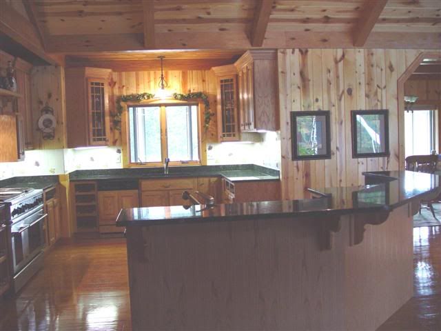 A kitchen with wooden cabinets and granite counter tops