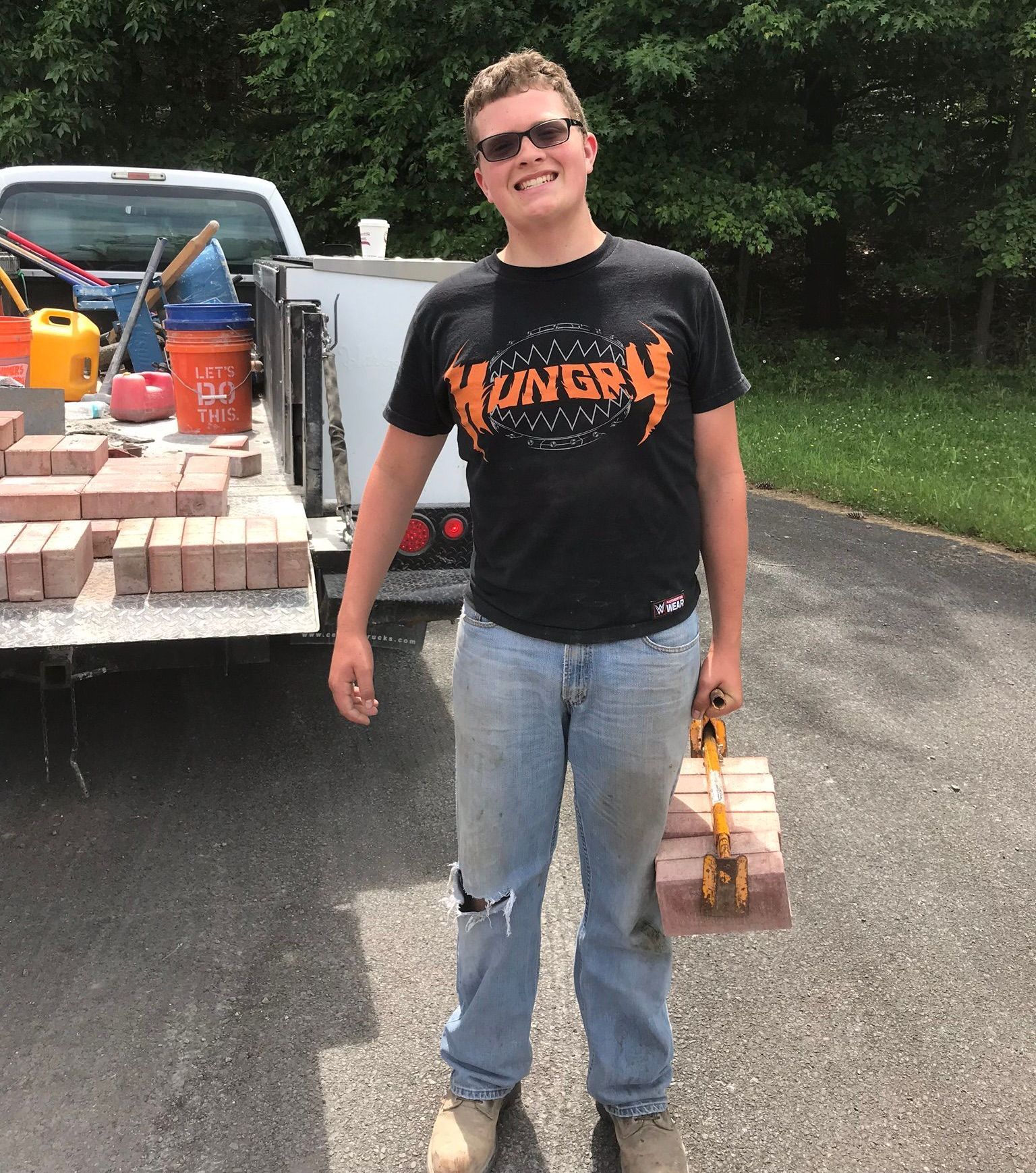 A group of men are working on a set of outdoor steps.