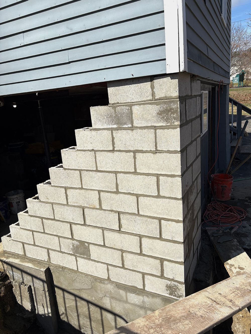 A brick wall is being built on the side of a building.
