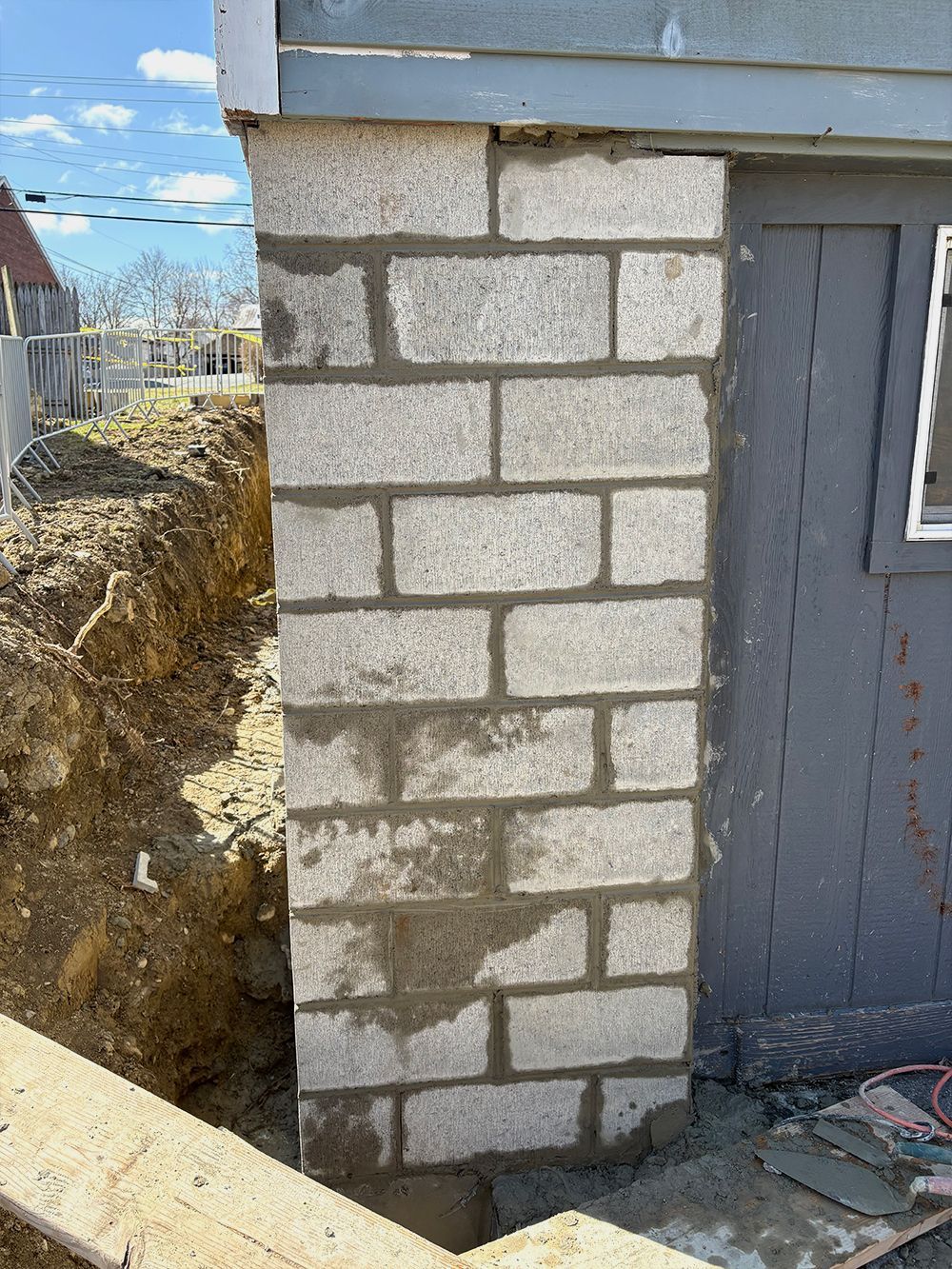 A brick wall is being built on the side of a building.