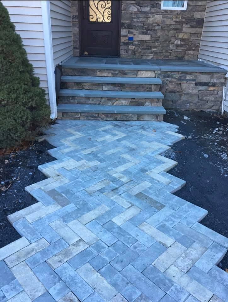 A stone walkway leading to the front door of a house.