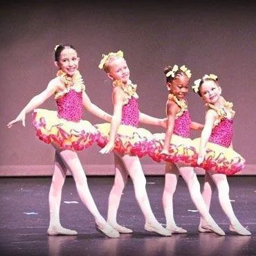 Three children dressed as daisy duck are posing for a picture