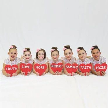 A group of young women posing for a picture with bows in their hair