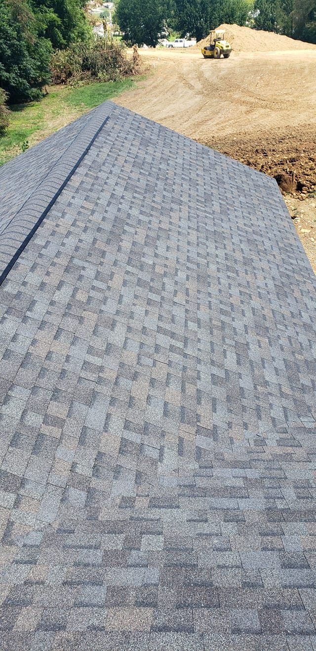 A close up of a roof with a field in the background.