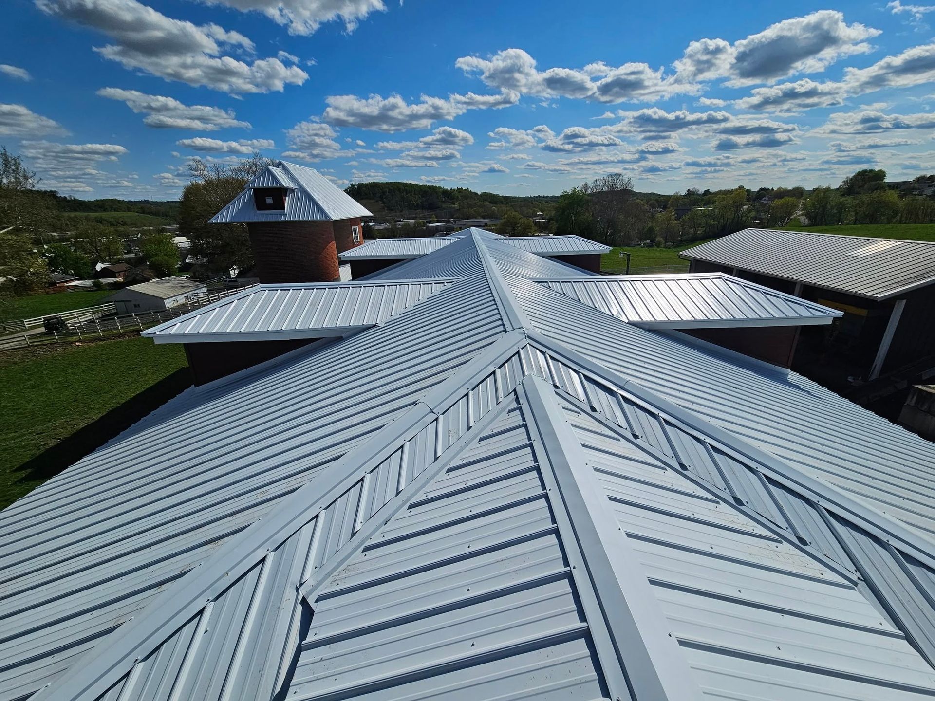 An aerial view of a house 's roof on a sunny day.