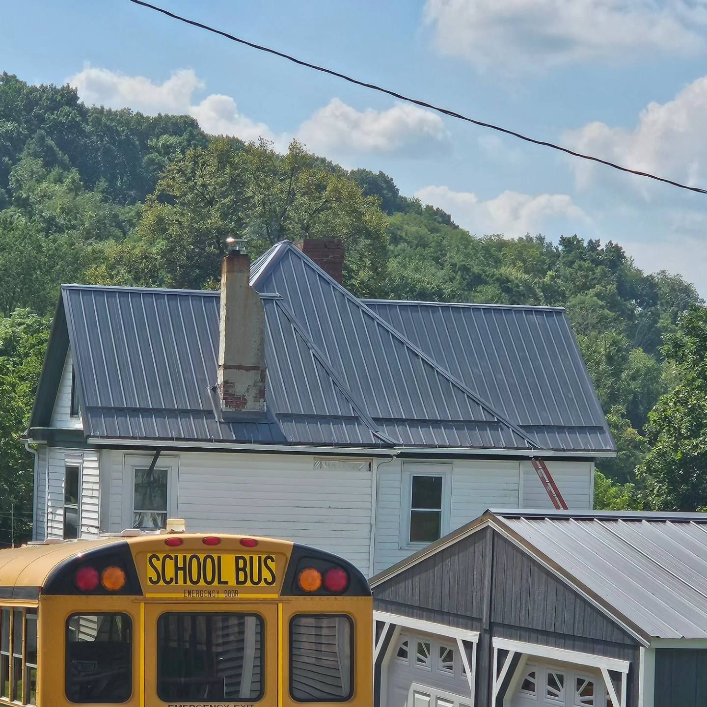 A yellow school bus is parked in front of a house