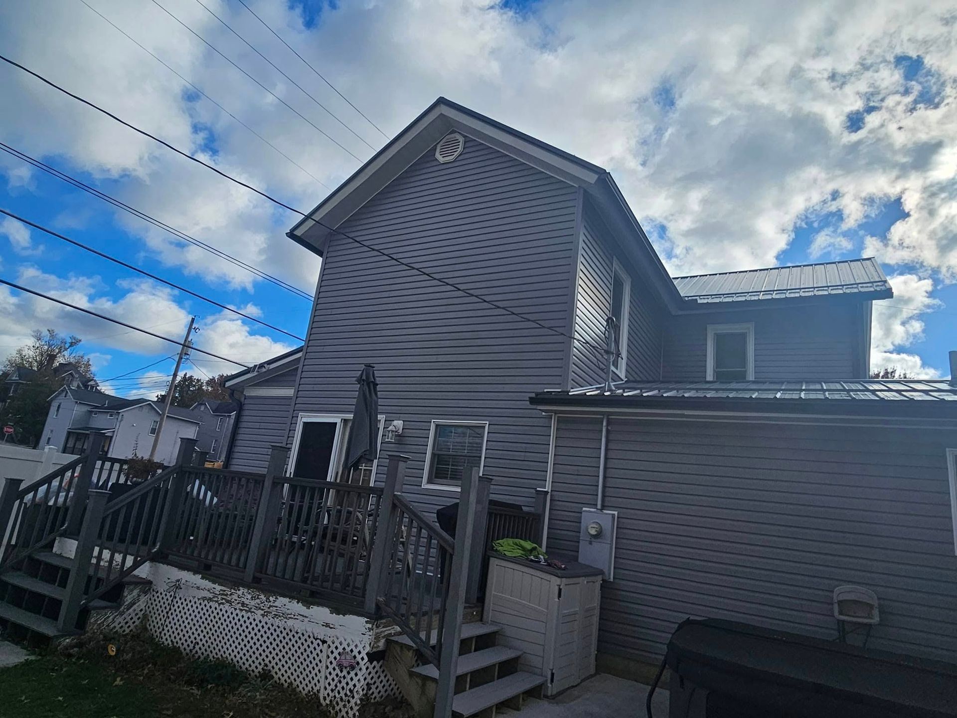 The back of a house with a deck and stairs.