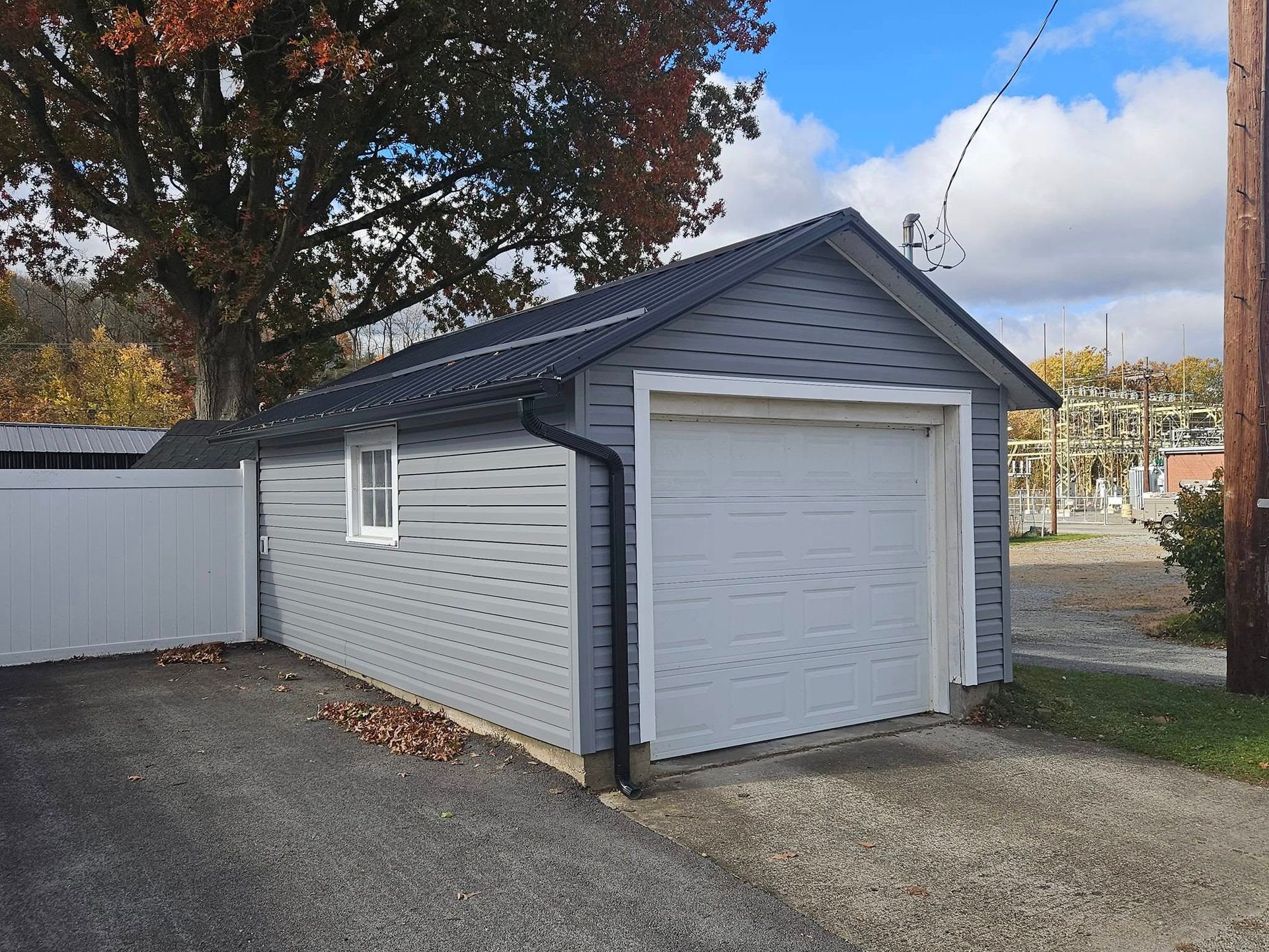 A small garage with a white door and a window