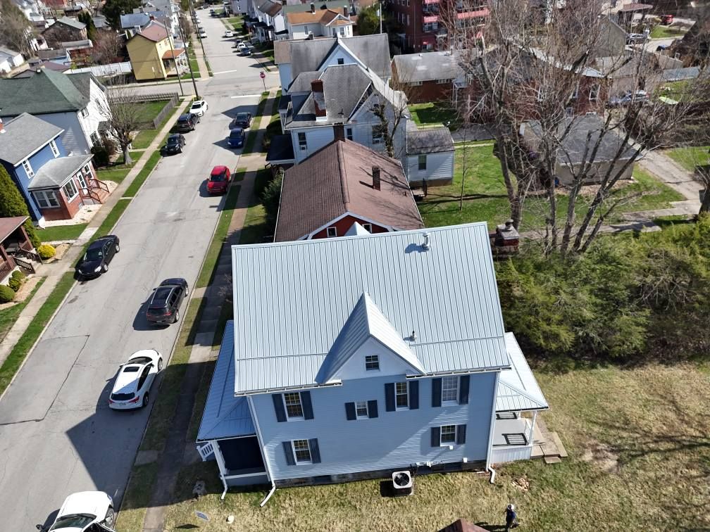 An aerial view of a house in a residential neighborhood
