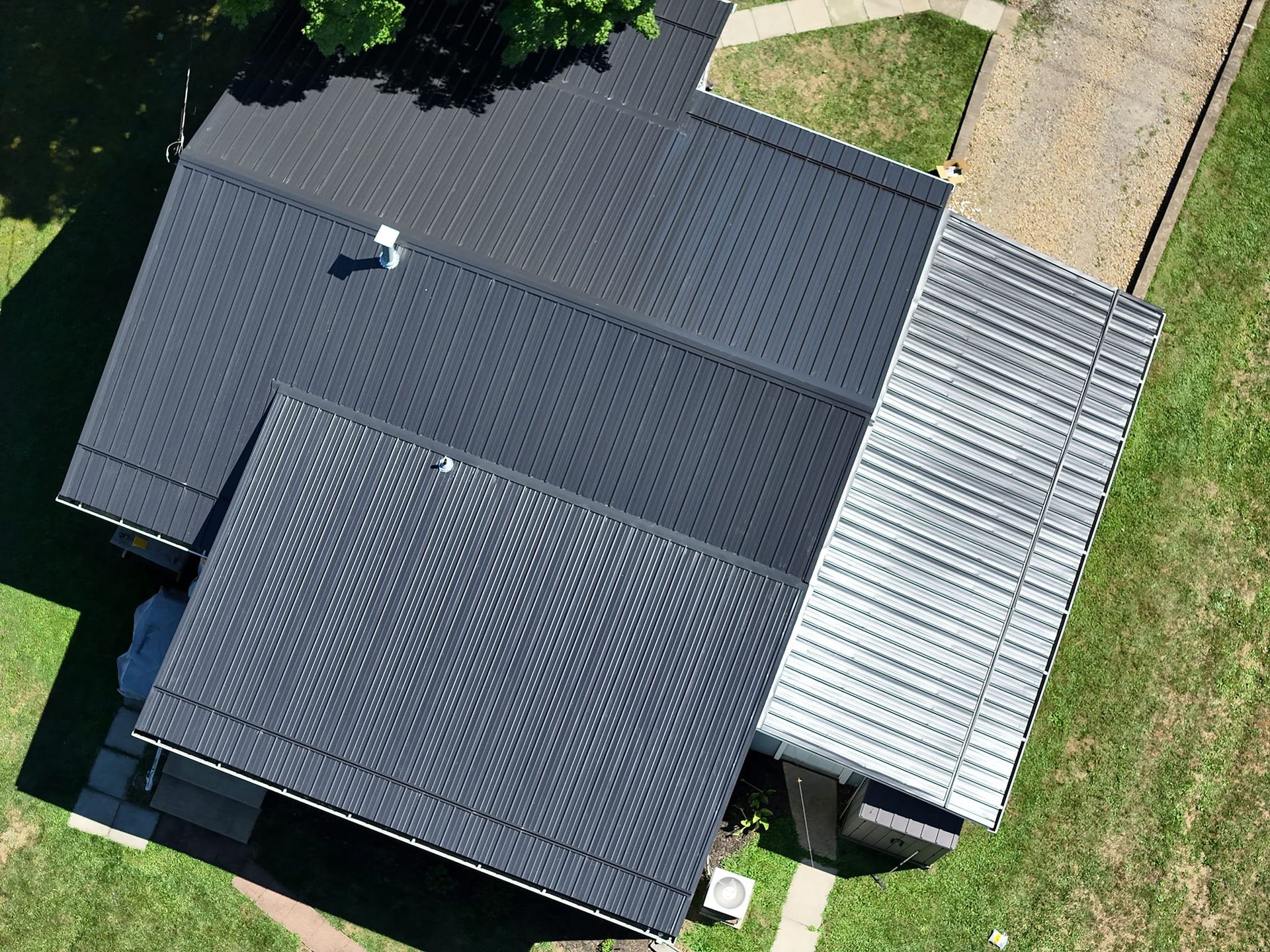 An aerial view of a house with a black roof