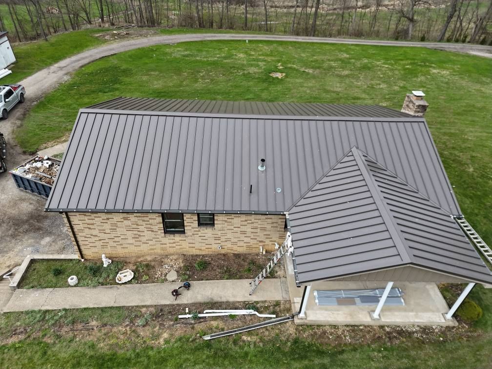 An aerial view of a house with a metal roof.
