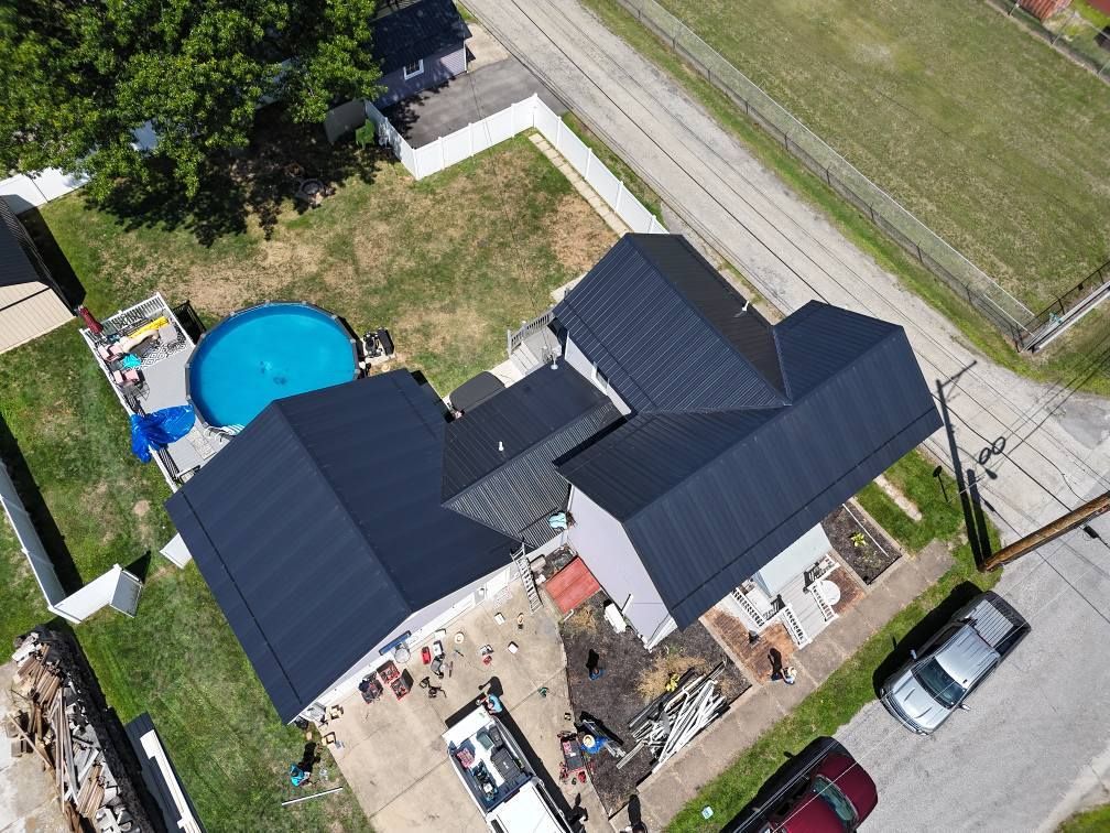 An aerial view of a house with solar panels on the roof.