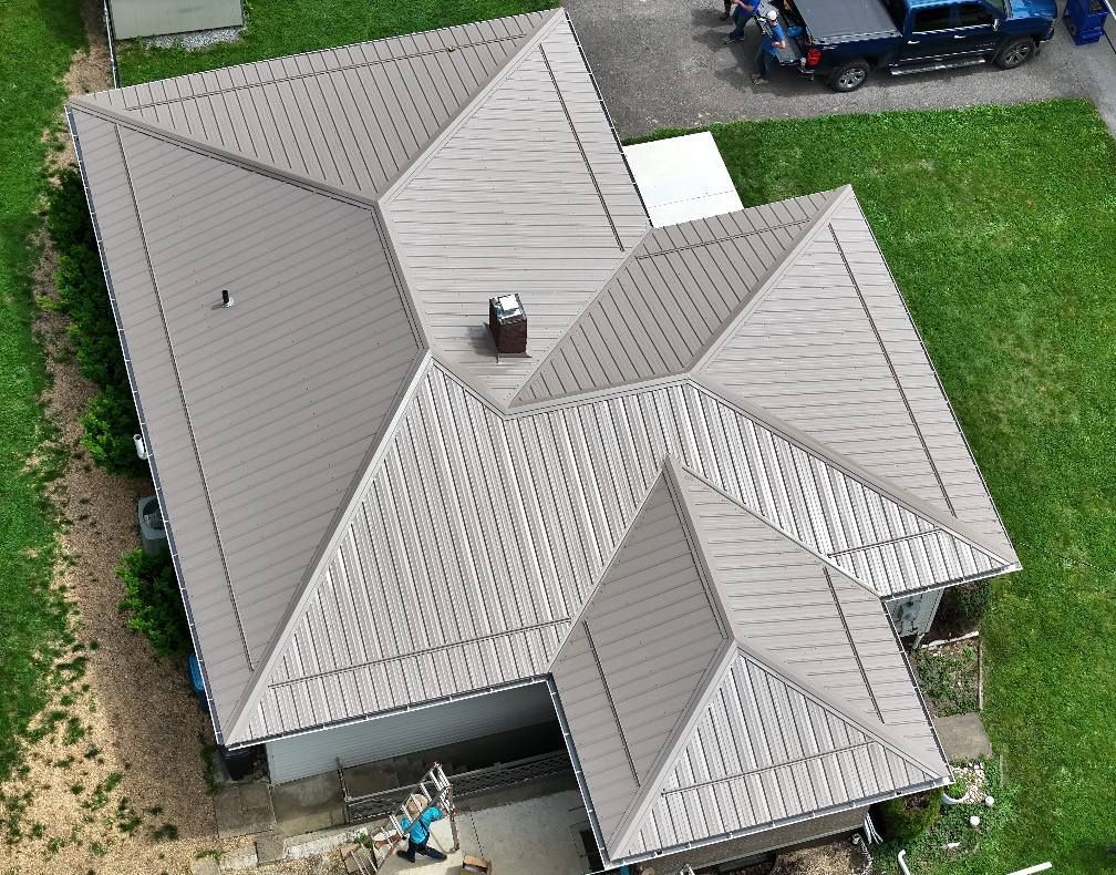 An aerial view of a house with a gray roof