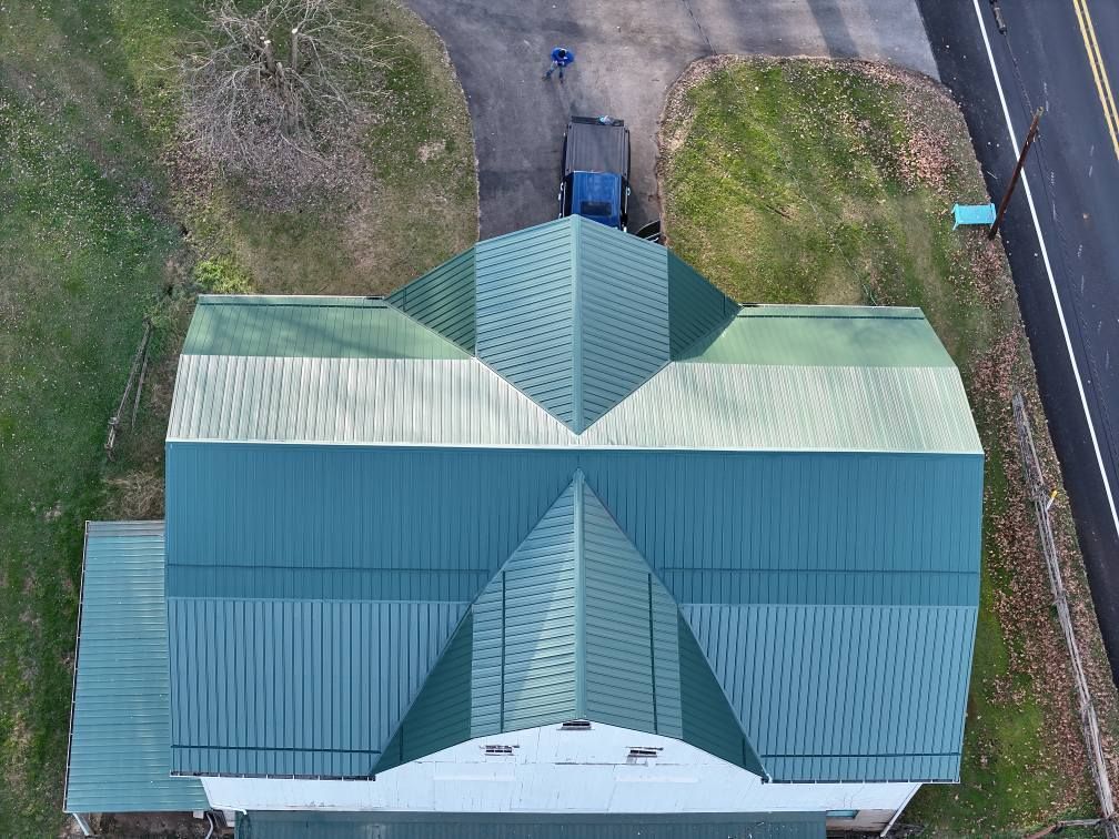 An aerial view of a house with a green roof