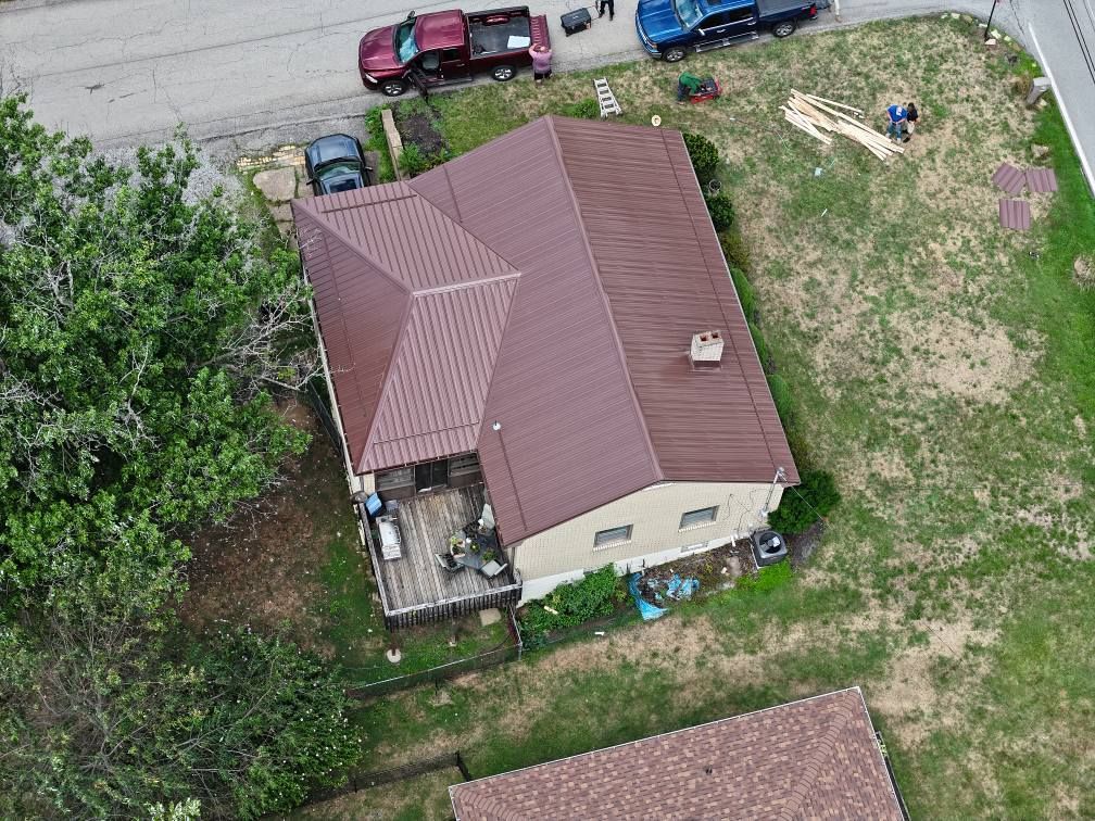An aerial view of a house with a brown roof.