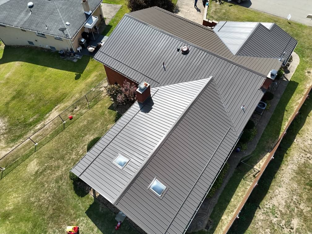 An aerial view of a house with a metal roof.