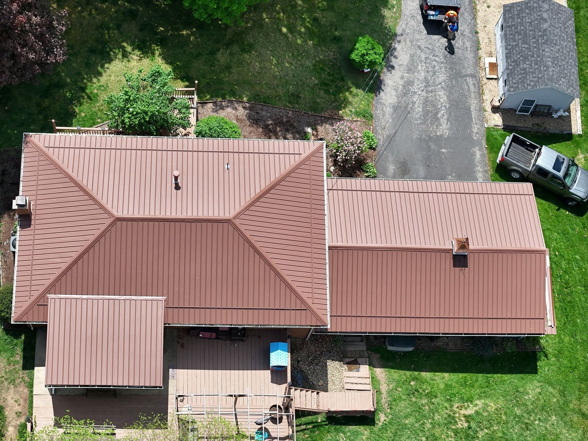An aerial view of a house with a brown roof