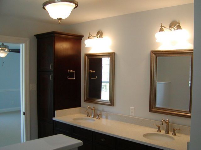 A bathroom with two sinks and two mirrors