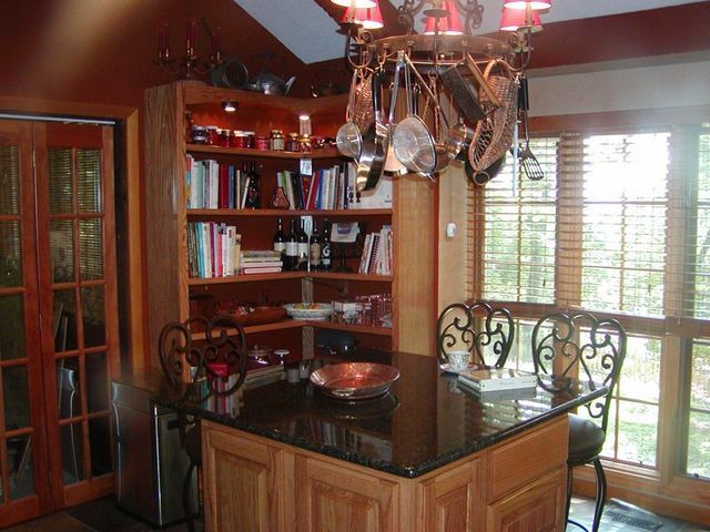 A kitchen with a large island and a chandelier hanging from the ceiling