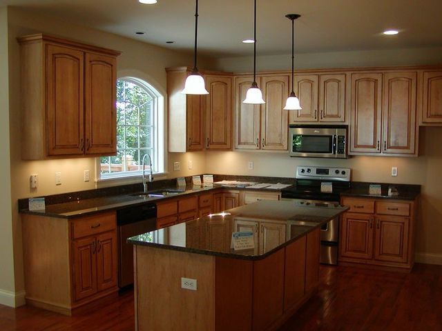 A kitchen with stainless steel appliances and wooden cabinets