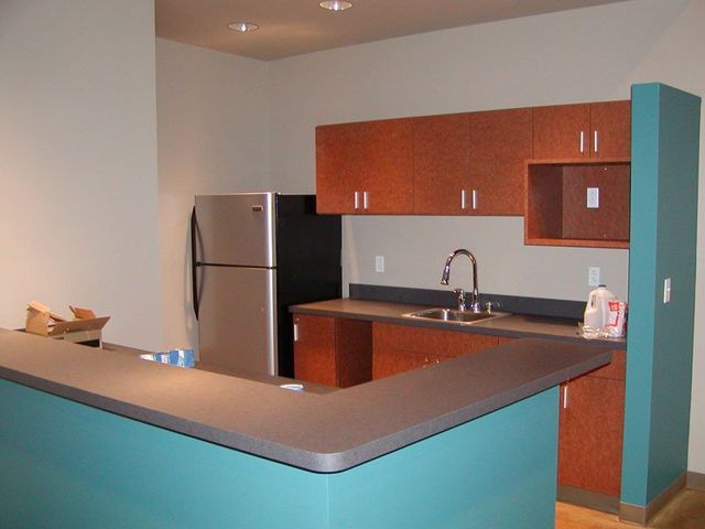 A kitchen with stainless steel appliances and wooden cabinets