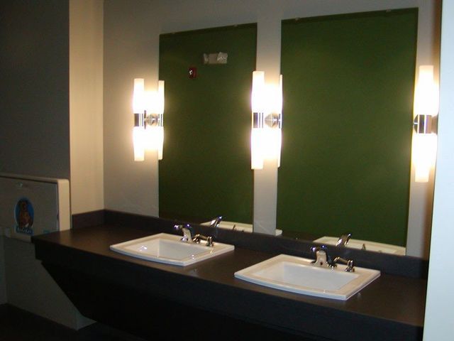 A bathroom with two sinks and two mirrors