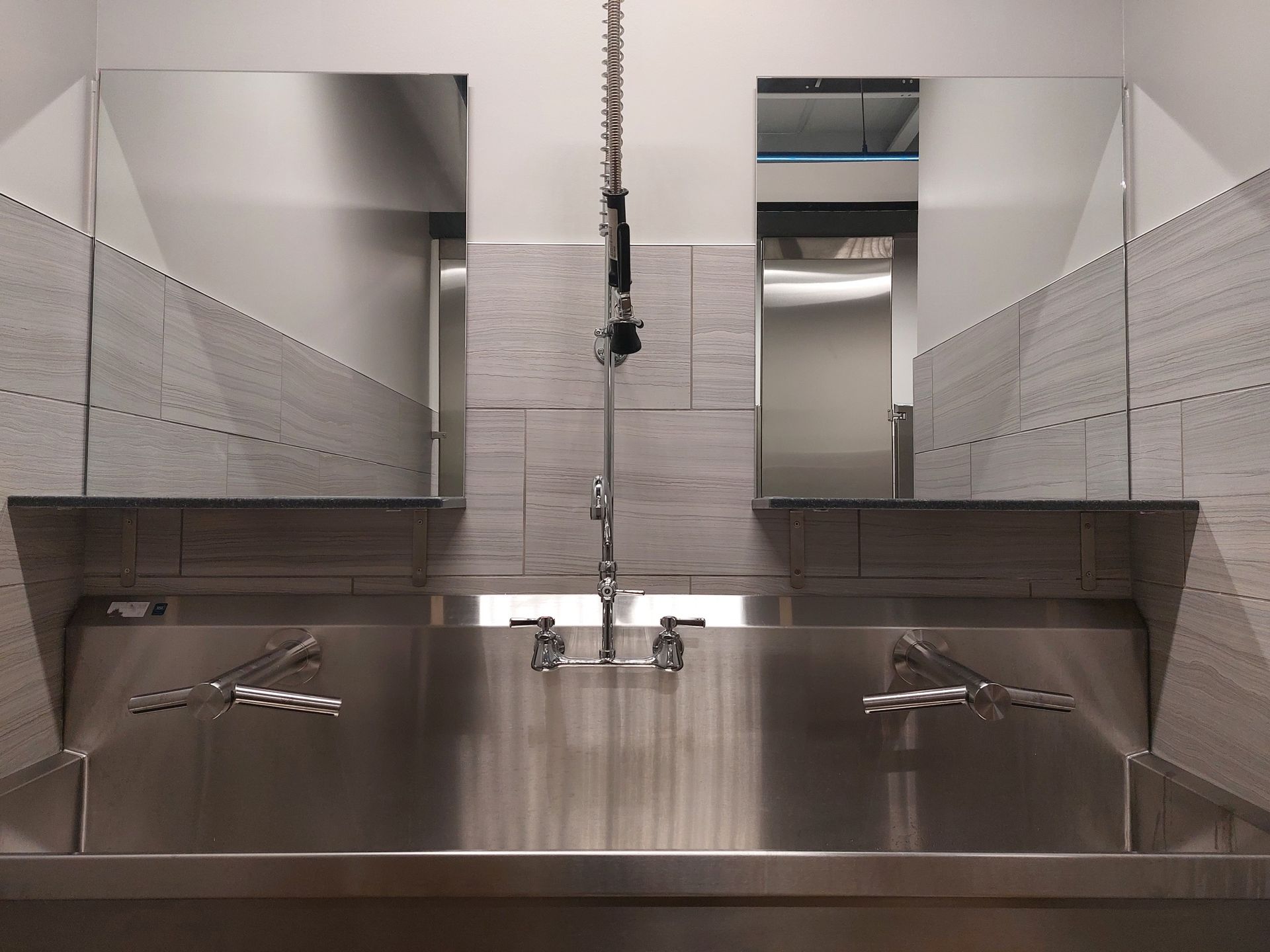 A bathroom with two sinks and two mirrors