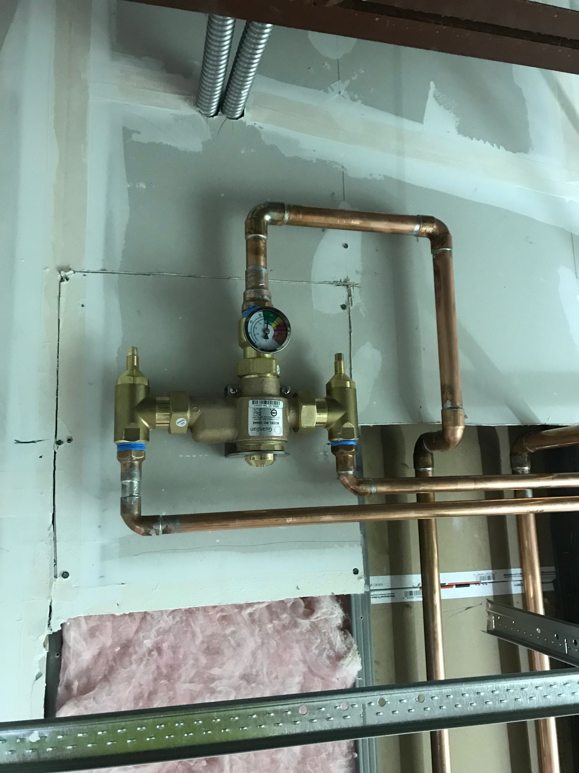 A copper pipe with a gauge attached to it