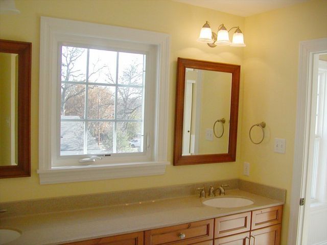 A bathroom with two sinks and two mirrors