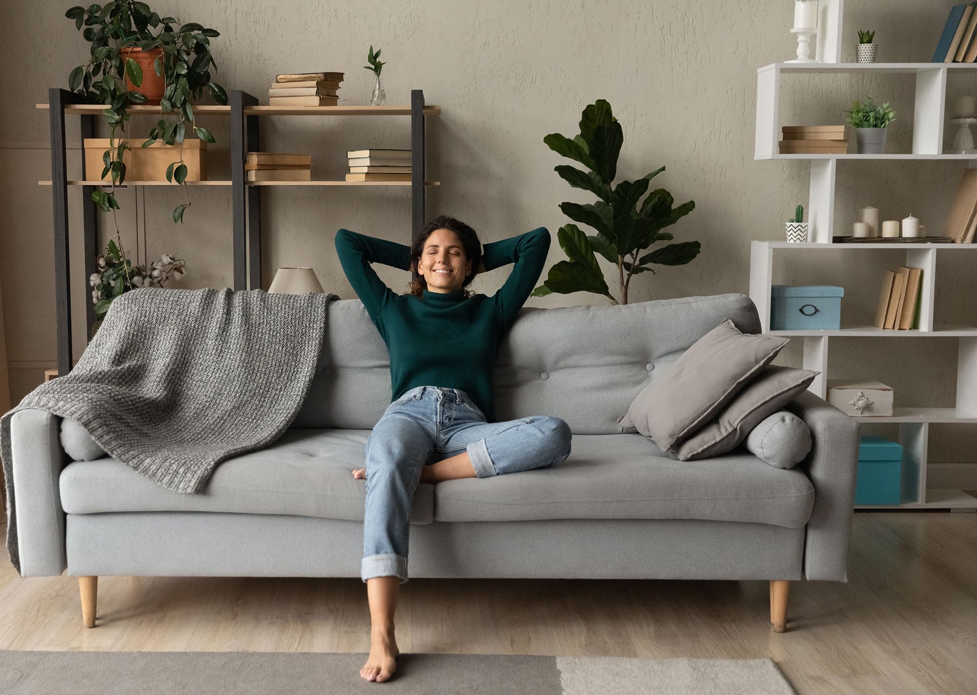 White air purifier blowing air in a child's bedroom with a bed and teddy bear.