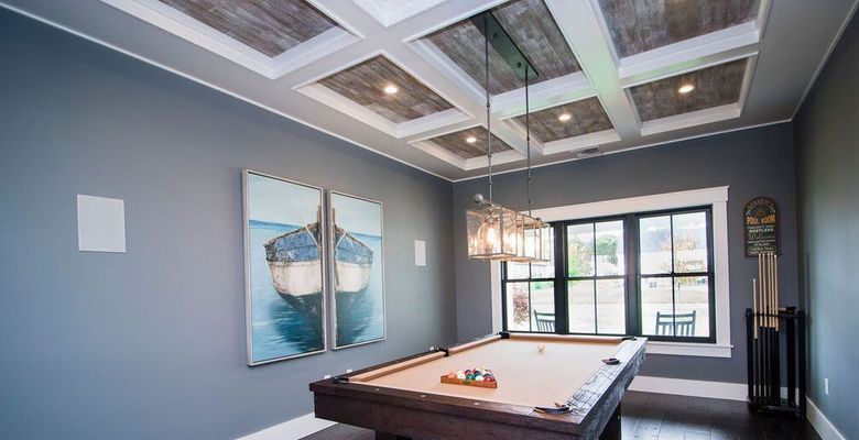 Pool room with gray walls, wooden ceiling, pool table, and art of a boat.