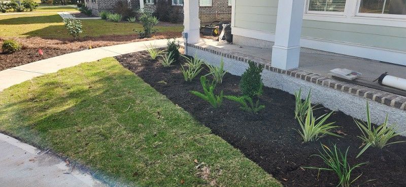 A house with a lush green lawn and a walkway in front of it.