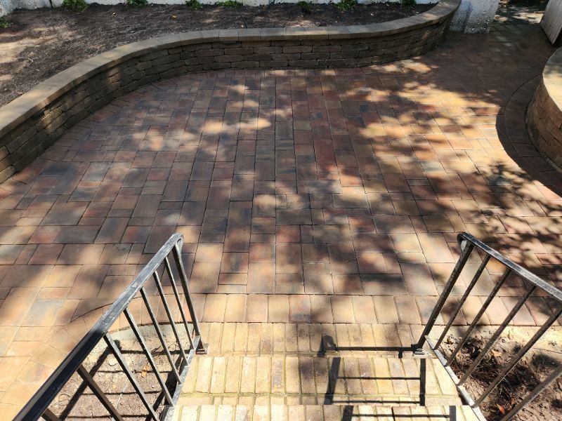 A set of stairs leading up to a brick patio.