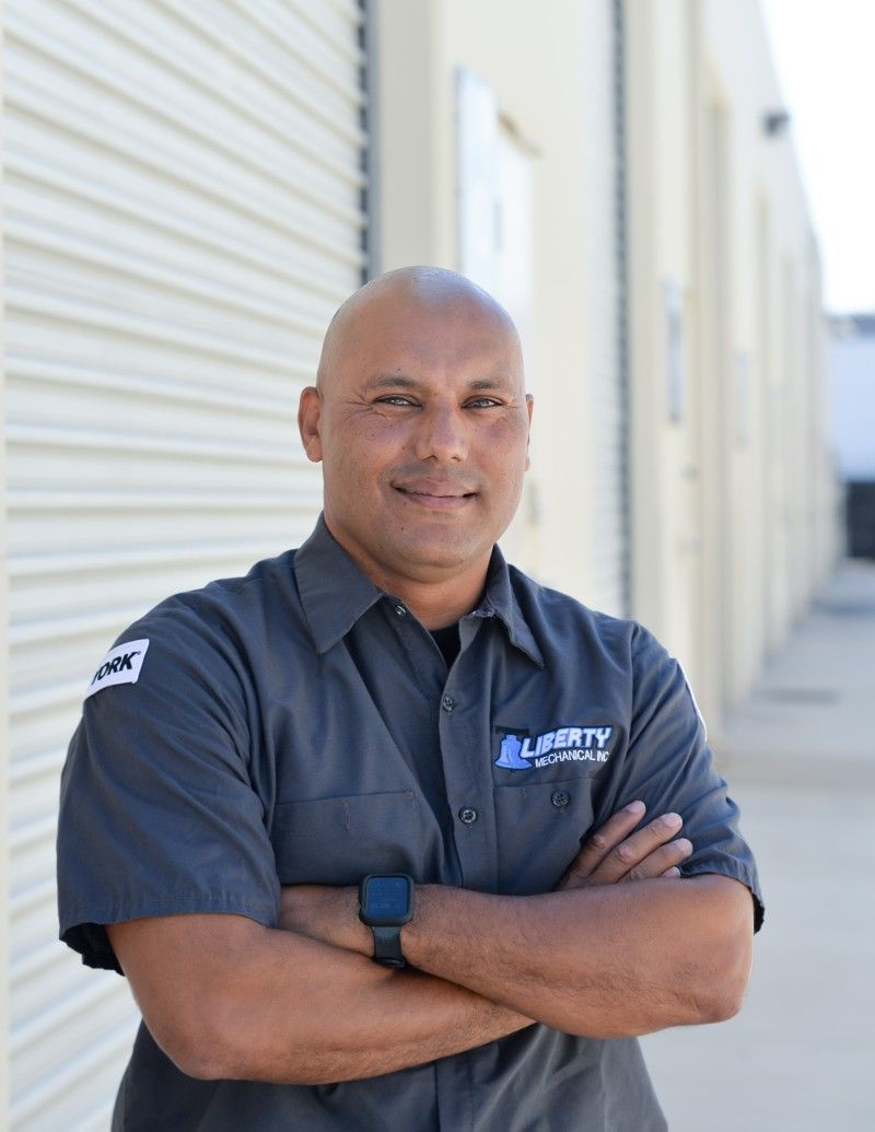 A man with his arms crossed is wearing a liberty shirt