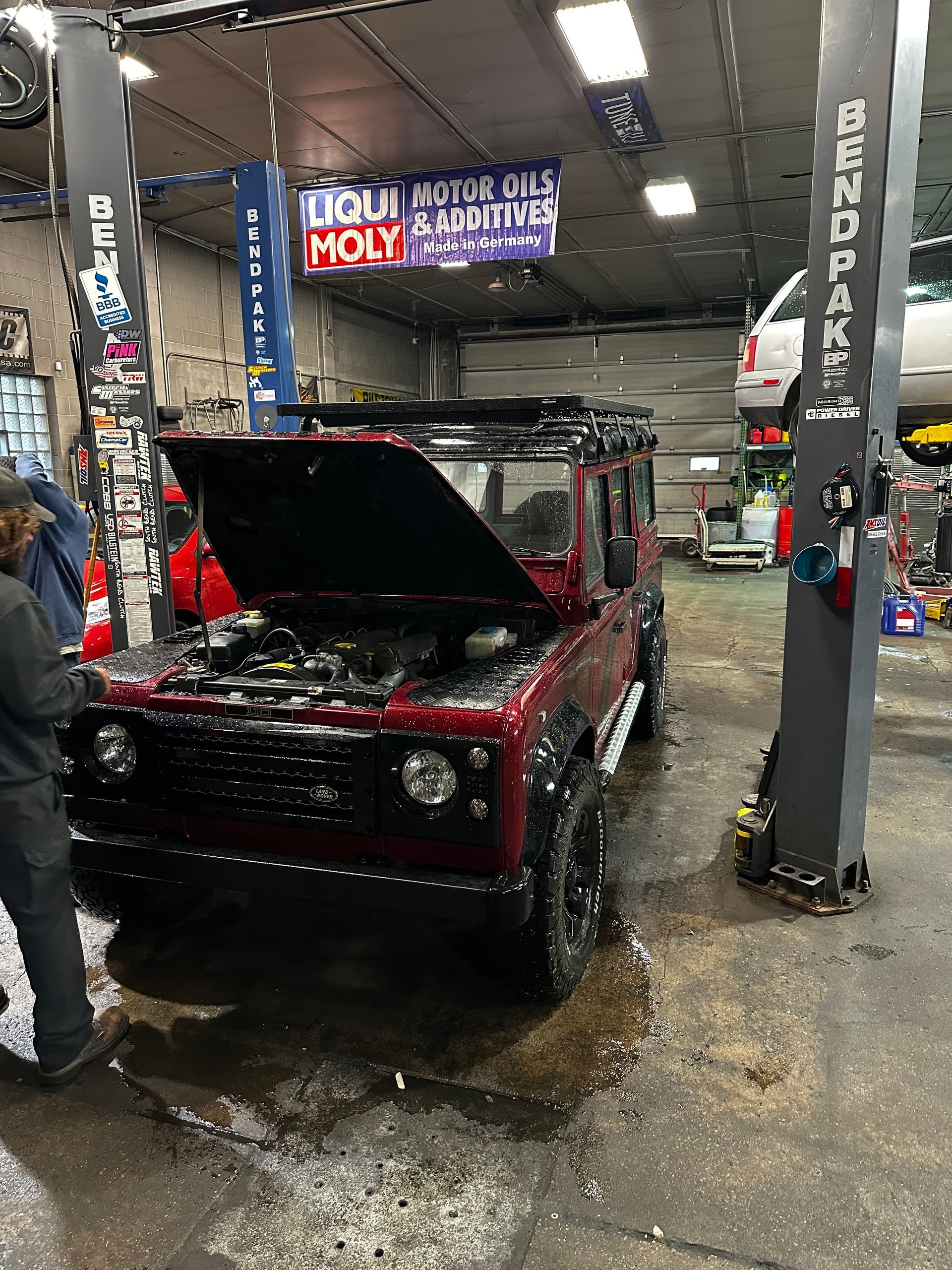 A man is working on a vehicle in a garage