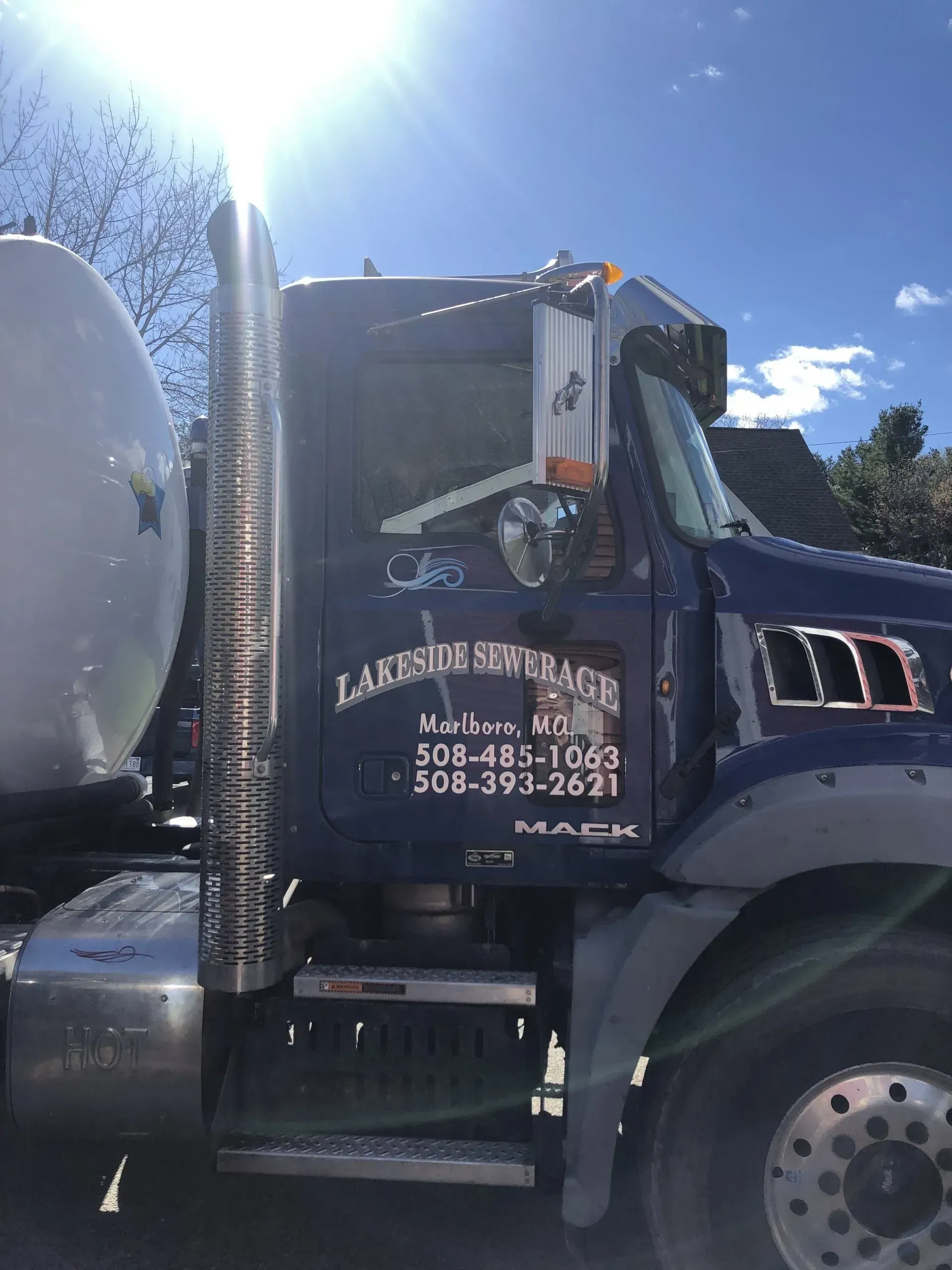 Blue Lakeside Sewer Service truck in daylight.