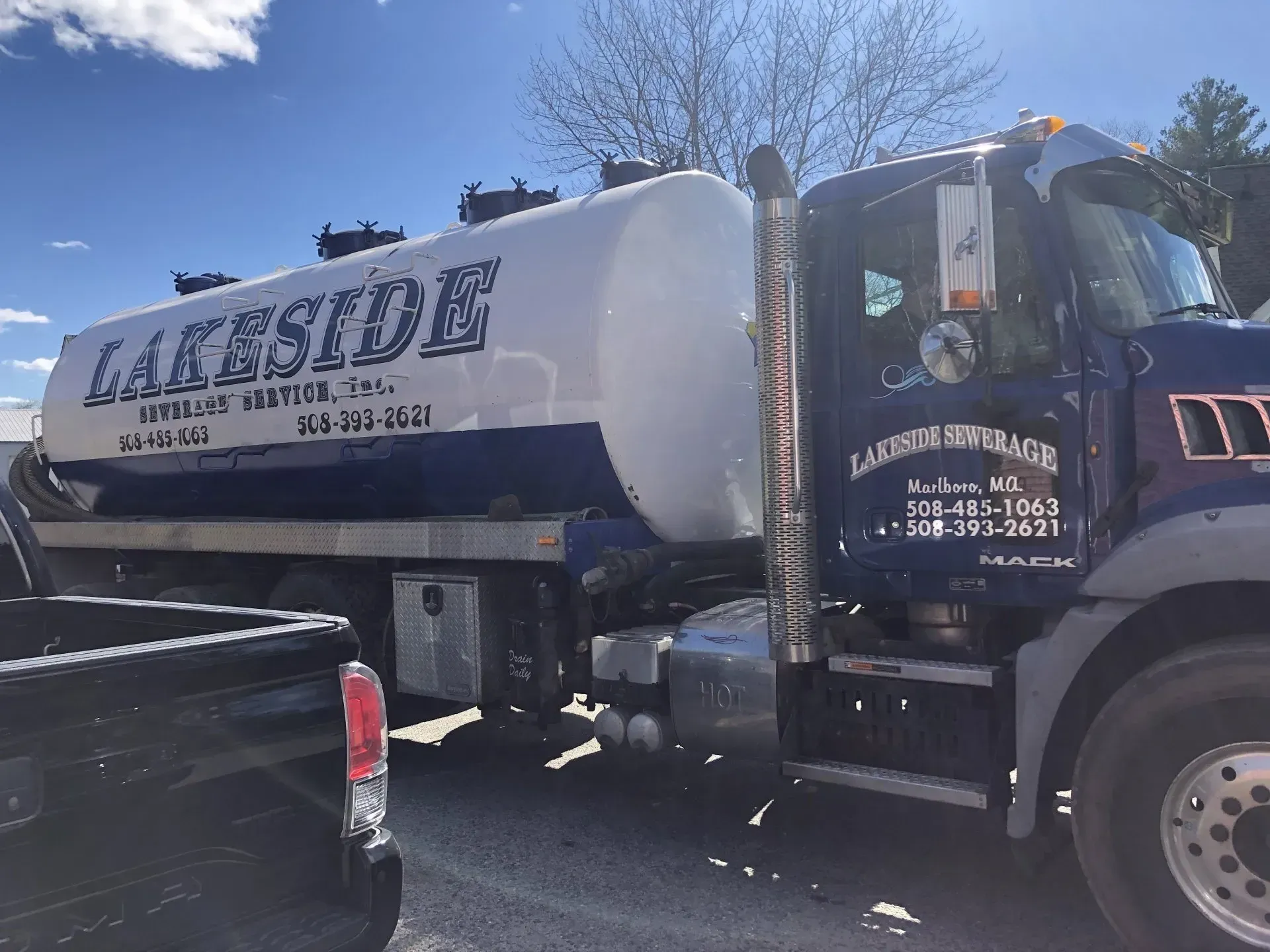 Blue and white Lakeside Septic truck, parked outdoors.