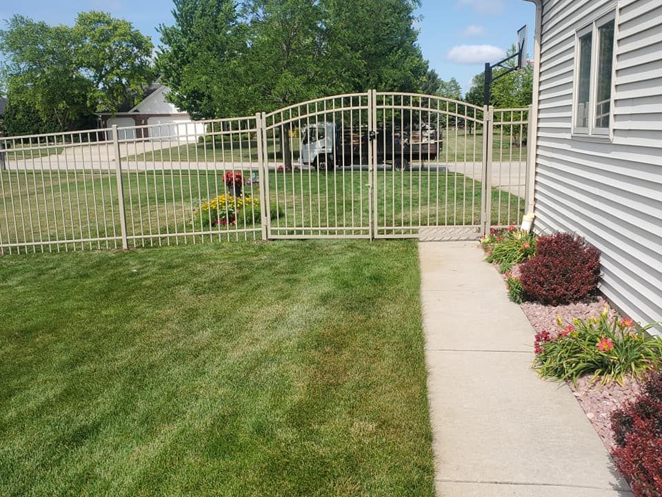 A white house with a fence and a walkway leading to it.