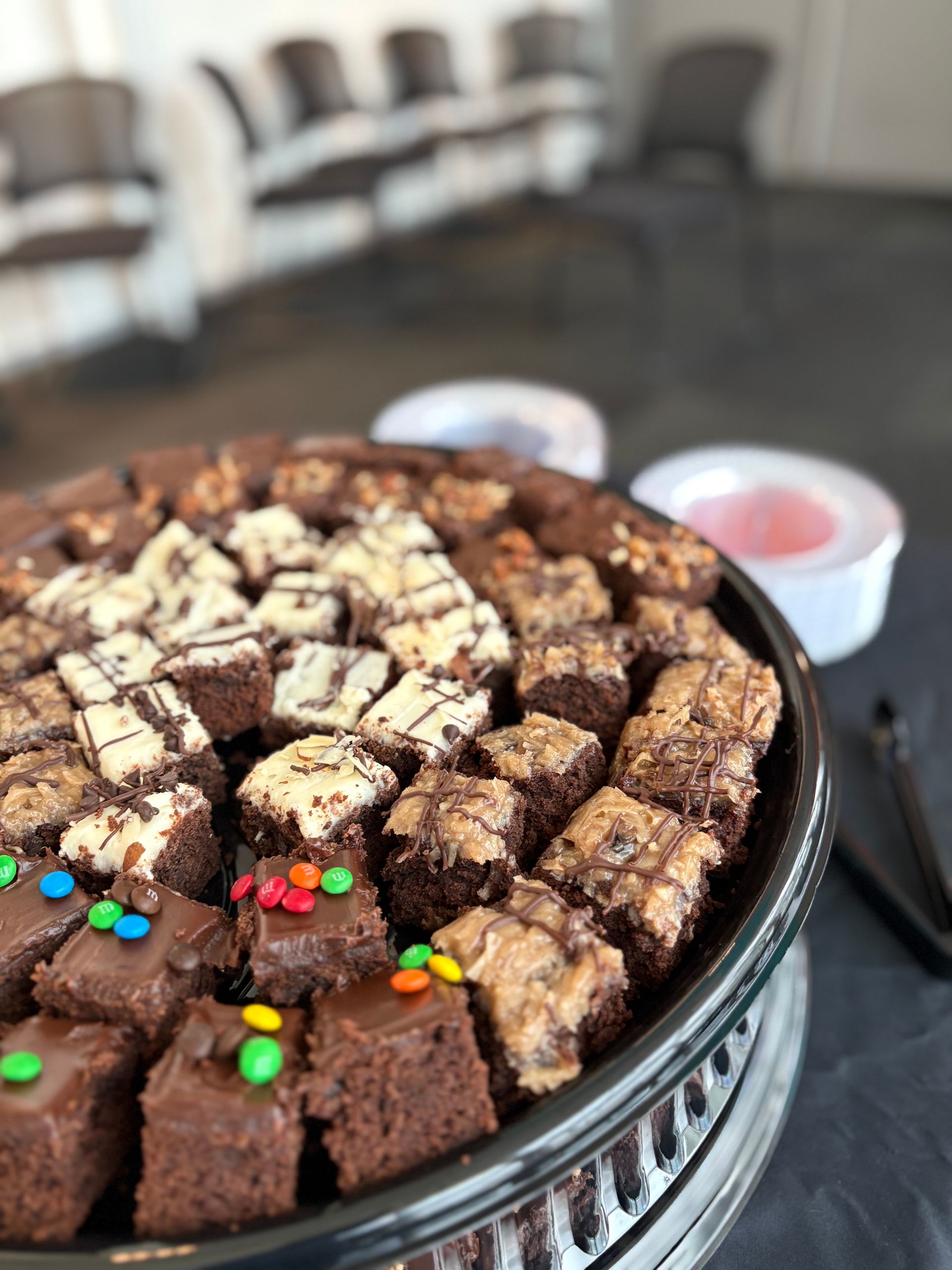 Brownie platter with various toppings and a small dipping cup.