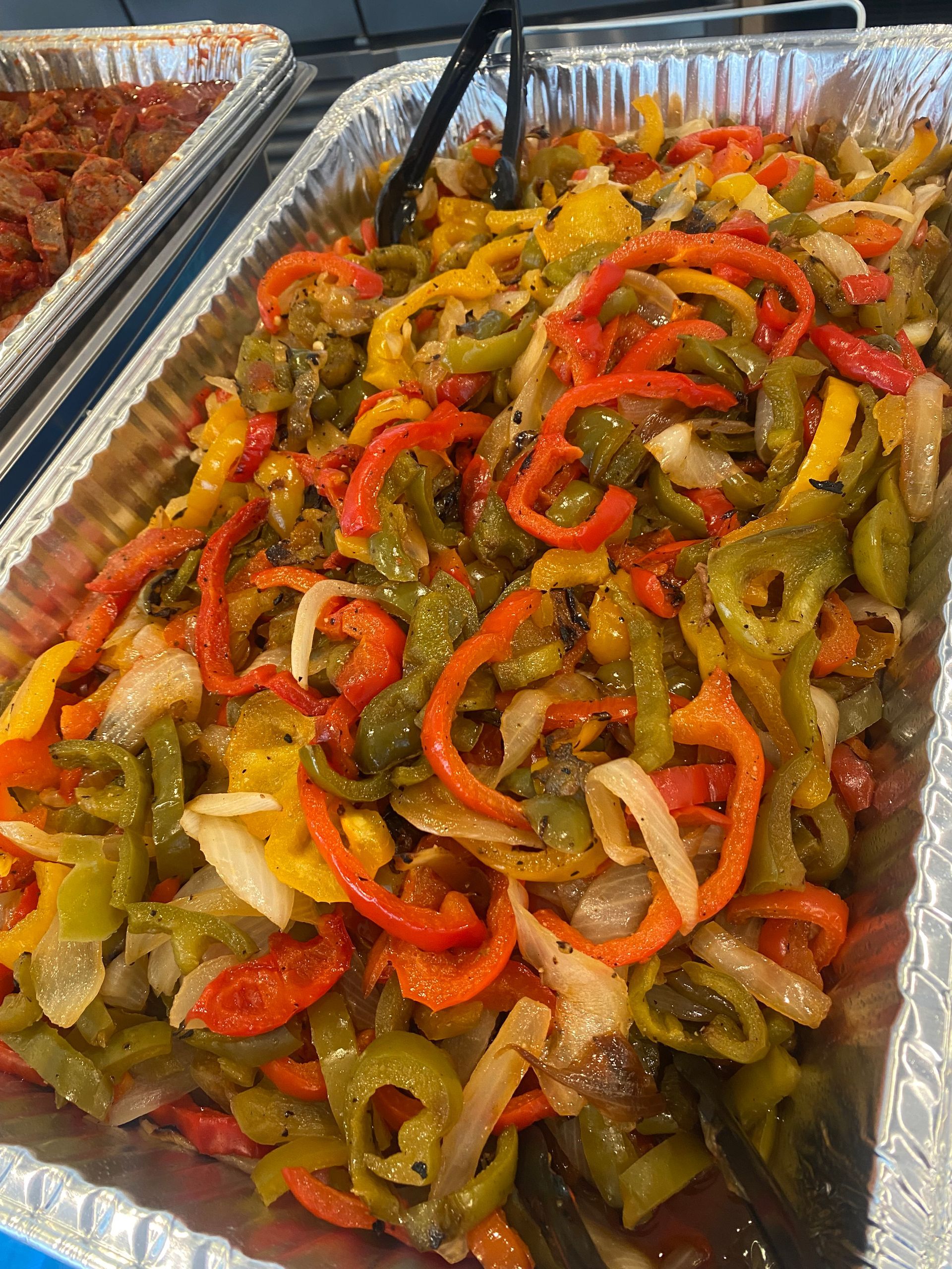 Tray of colorful sautéed peppers and onions.