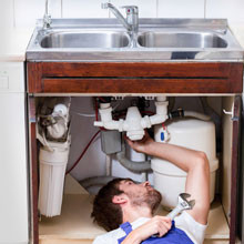 Man repairing kitchen sink
