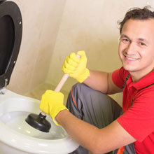 Plumber is cleaning sink