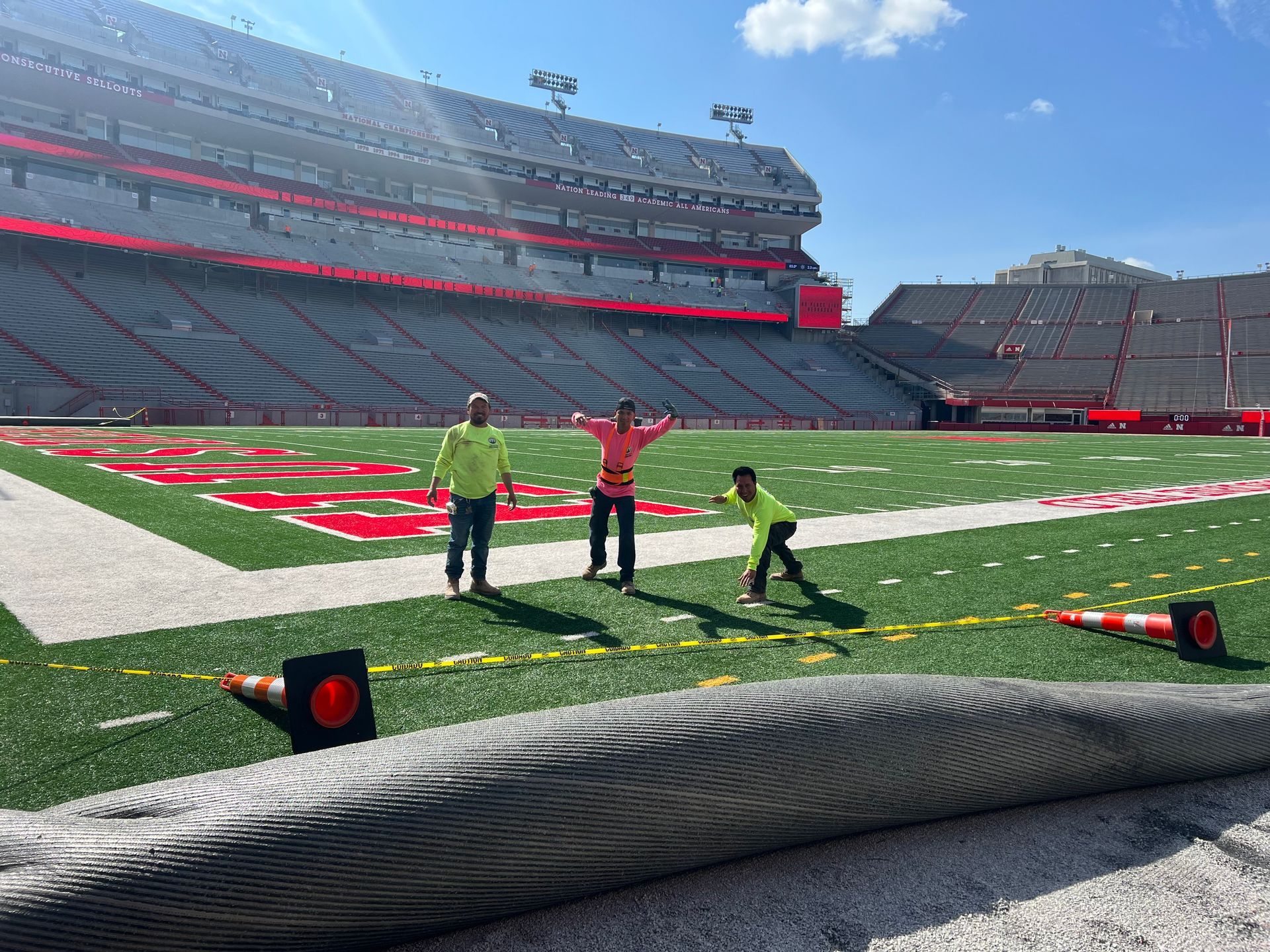 A group of people are standing on top of a football field