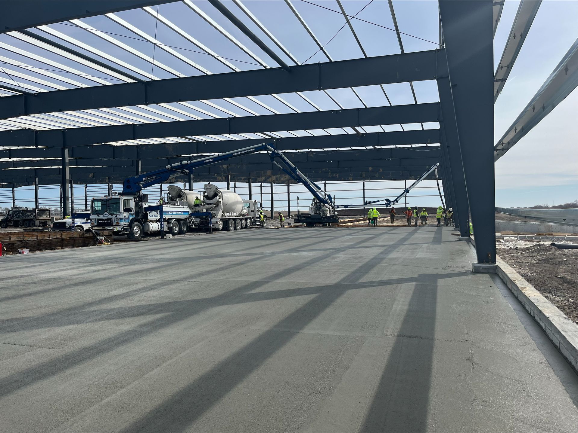 A construction site with a lot of trucks and workers