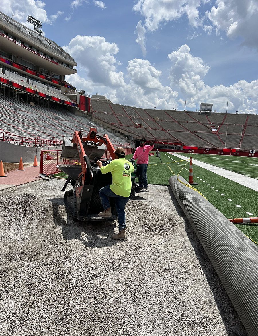 A group of people are working on a football field