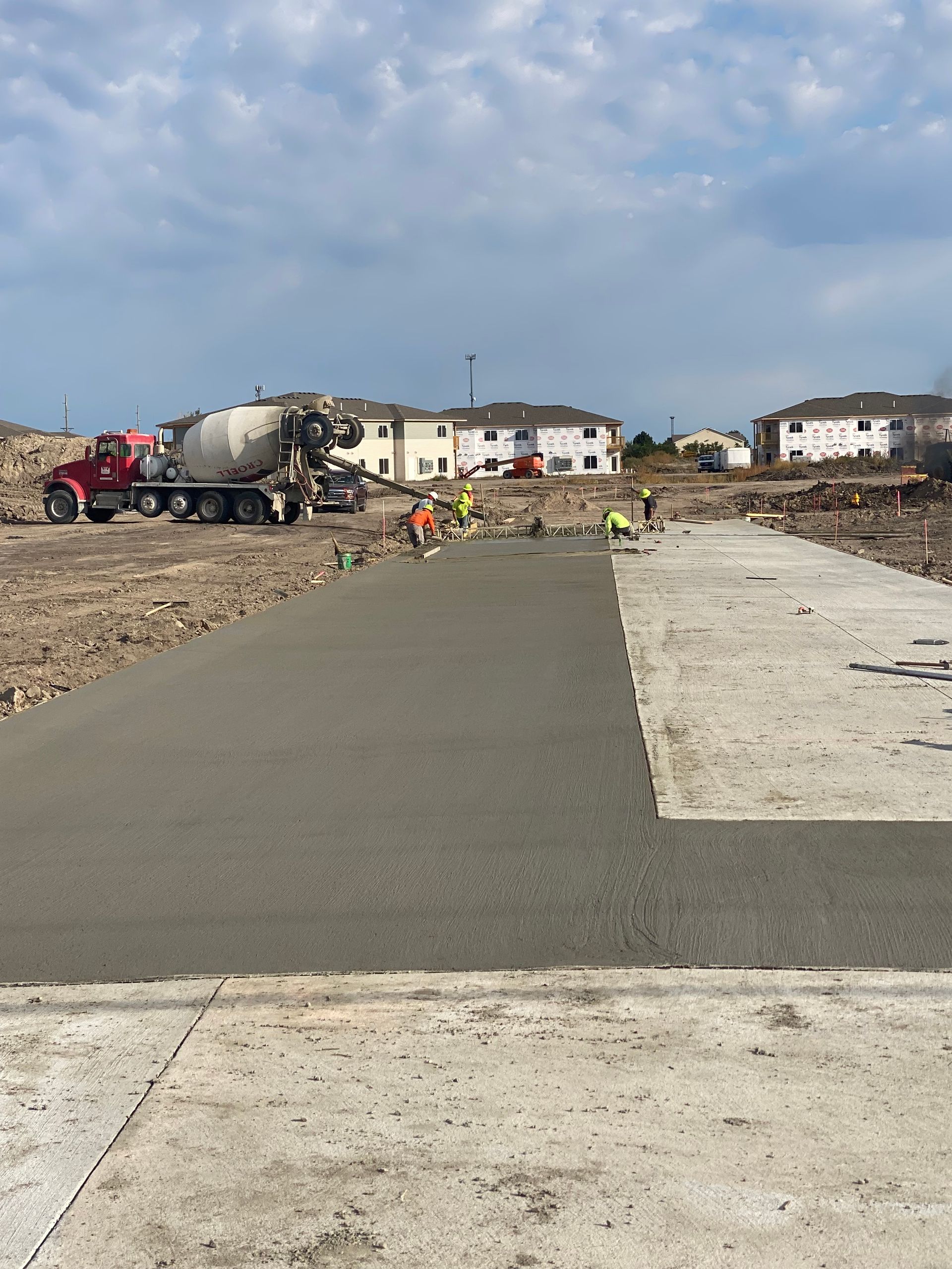 A concrete driveway is being built on a construction site