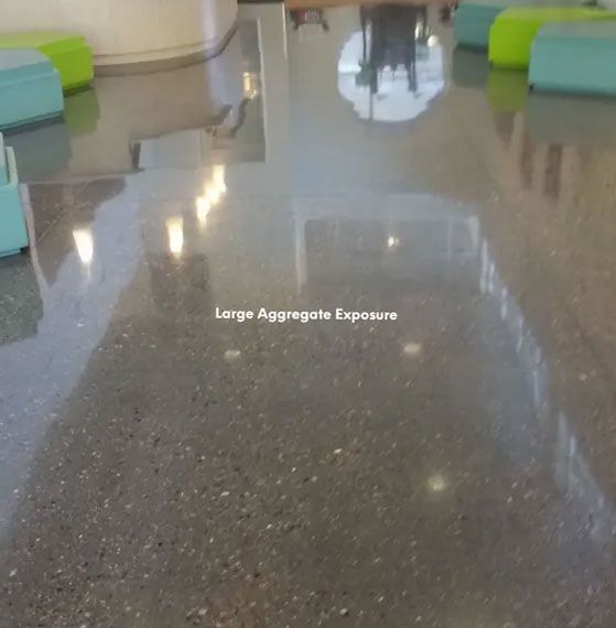 Polished concrete floor with large aggregate exposure in a building.