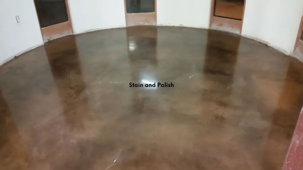 Brown metallic epoxy flooring in a circular room, reflecting light.