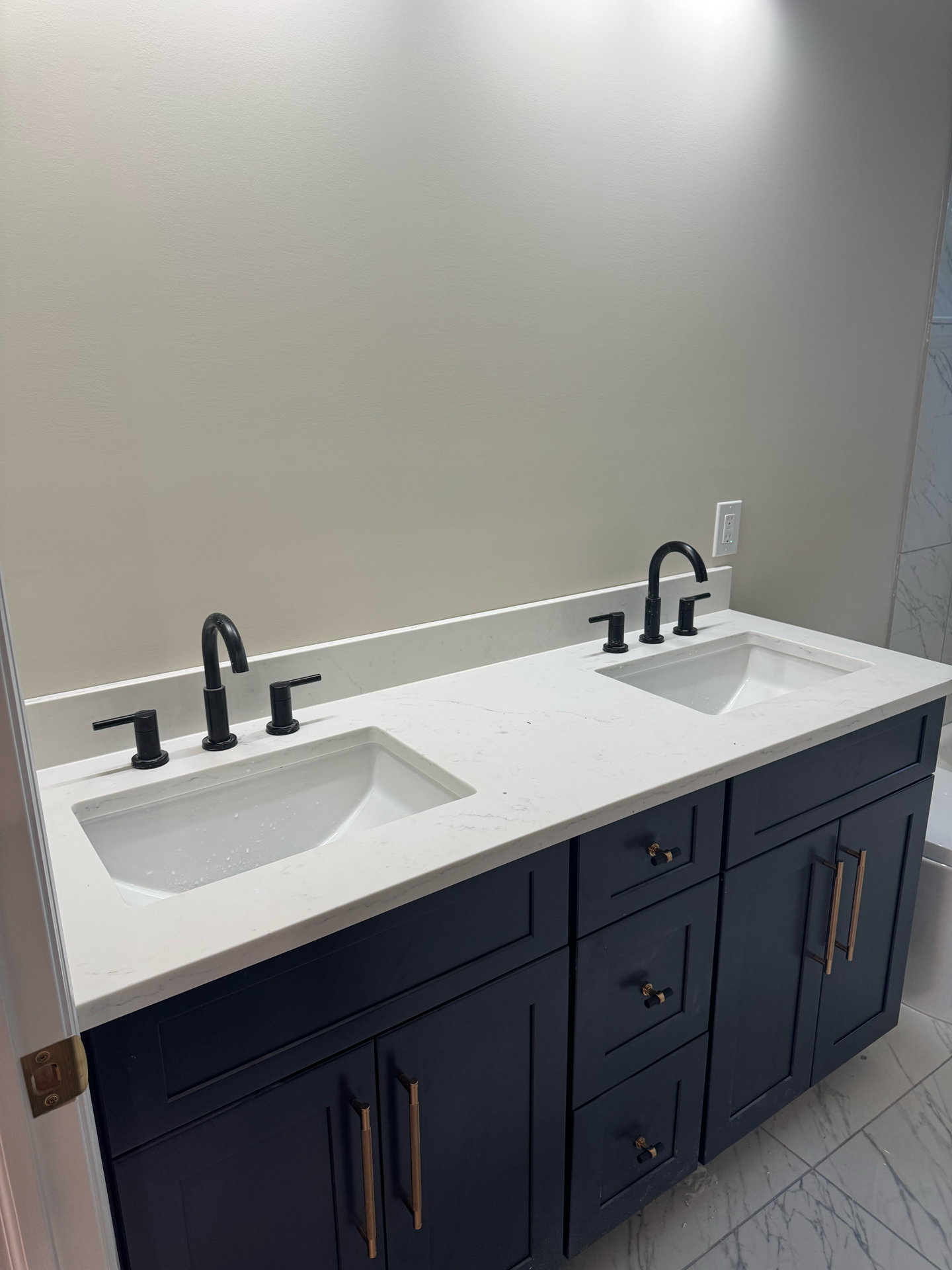 A bathroom vanity with two sinks and a mirror.