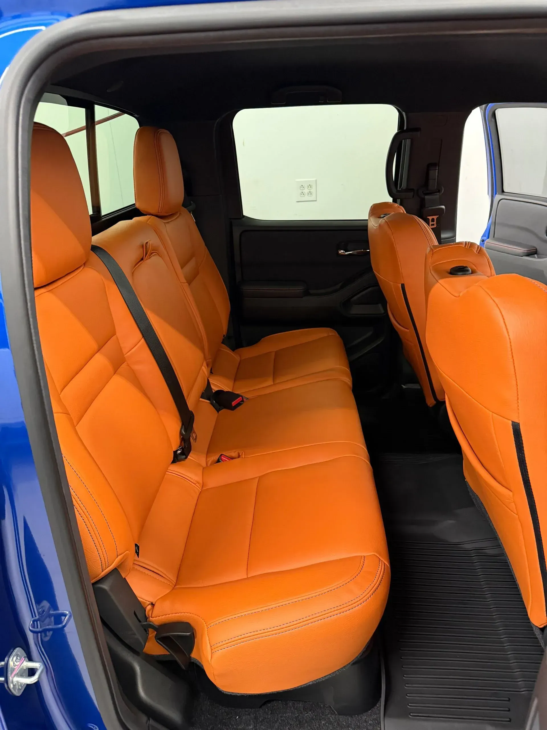 Orange leather interior of a blue pickup truck.